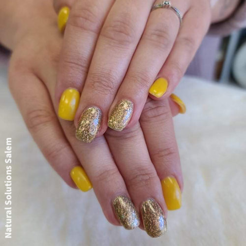 acrylic nails with yellow and gold gel polish by artist Stacey Kasle