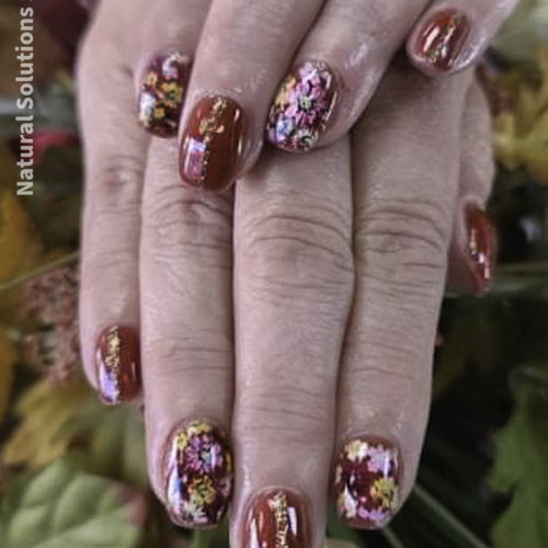 Natural Solutions Salem Ohio offers acrylic nail services with fall floral polish designs by Stacey